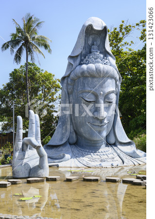 Guanyin statue, half submerged in the blue sea, in the 18th-century Thanh Luong Buddhist Pagoda 131423066