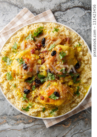 Moroccan Tfaya Couscous With Braised Chicken closeup on the plate. Vertical top view Moroccan Tfaya Couscous With Braised Chicken closeup on the plate. Vertical top view 131423456