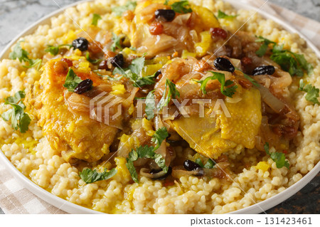 Savory sweet fragrant chicken couscous tfaya is a comforting and special meal closeup on the plate. Horizontal 131423461