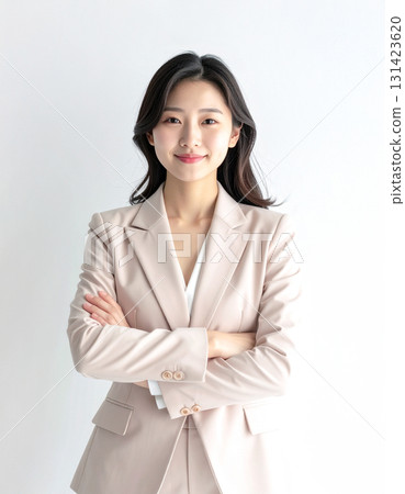 A young woman in a suit with her arms crossed A young woman in a suit with her arms crossed 131423620
