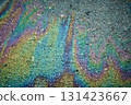 Iridescent oil spill creating rainbow colors on asphalt. 131423667