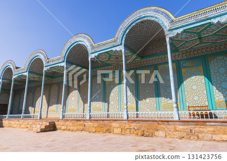 A sunlit courtyard features a row of scalloped arches, slender columns. Bukhara A sunlit courtyard features a row of scalloped arches, slender columns. Bukhara 131423756