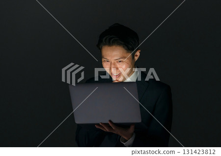 Suspicious man with computer 131423812