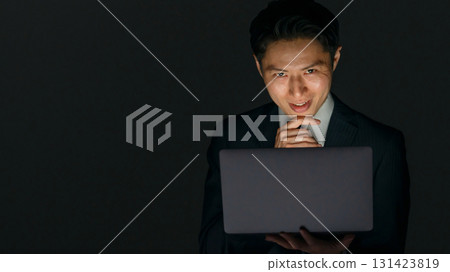 Suspicious man with computer 131423819