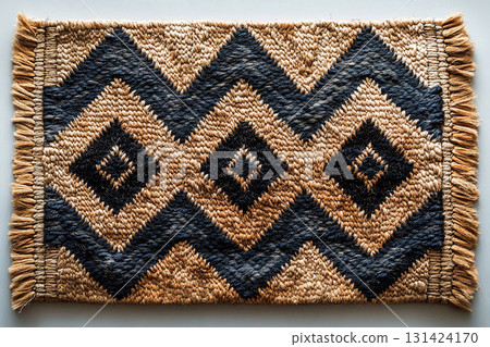 Handwoven rug texture with geometric print on a white background. Top view. 131424170