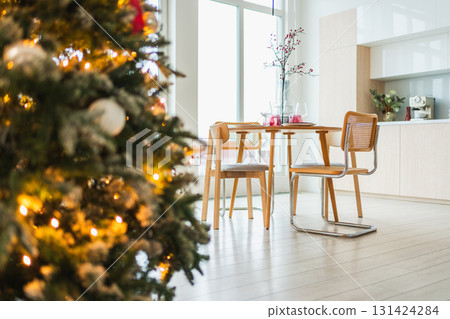Classical Christmas decorated interior kitchen. Modern classic style interior design apartment dining room and Christmas tree with red golden ornament decorations. Christmas eve at home 131424284