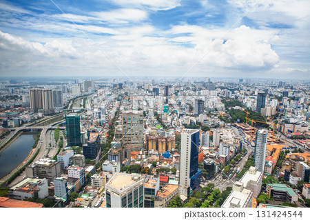 Aerial cityscape of Ho Chi Minh City ( Saigon ), Vietnam, showcasing modern skyscrapers, dense urban layout, and river. Biggest Vietnamese metropolis at south part of county on a bright sunny day. Aerial cityscape of Ho Chi Minh City ( Saigon ), Vietnam, showcasing modern skyscrapers, dense urban layout, and river. Biggest Vietnamese metropolis at south part of county on a bright sunny day. 131424544