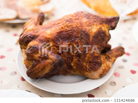 whole roasted chicken on a plate 131424686