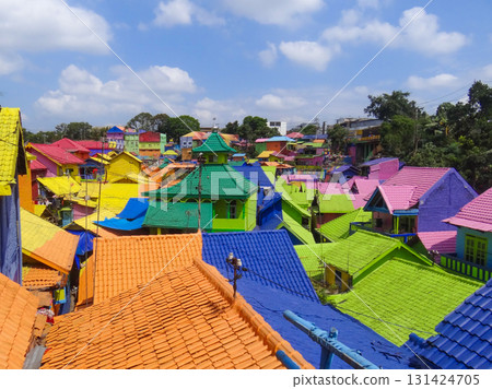 Aerial view of vibrant rooftops in Kampung Warna Warni Jodipan, Malang, East Java, Indonesia. Famous rainbow village, perfect destination for urban tourism, travel blogging, and cultural exploration. 131424705