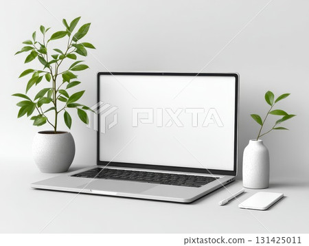 Laptop with clear screen on desk with greenery and mug. Ideal for workspace design, it features a fresh office look. Perfect for professionals. 131425011