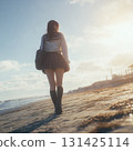 A high school girl in uniform standing on the beach at dusk 131425114