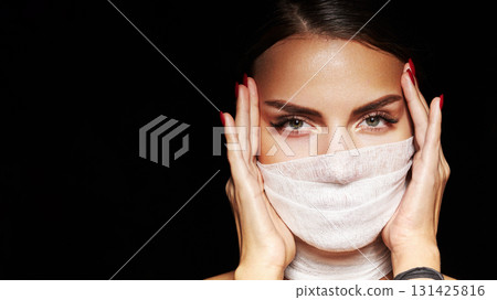 Attractive woman with bandage facial mask with glamorous makeup. Perfect brows, extreme long eyelashes and fashion look. Plastic surgery, aesthetic treatment concept, cosmetology or beauty lash salon 131425816