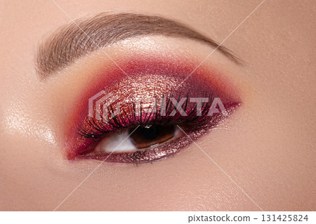Closeup of Woman Face with Eyes Make-up. Fashion Celebrate Makeup with Red Liner, Gold Shadows, Glowy Clean Skin, perfect Shapes of Brows. Macro of Female Eye. Halloween Style Closeup of Woman Face with Eyes Make-up. Fashion Celebrate Makeup with Red Liner, Gold Shadows, Glowy Clean Skin, perfect Shapes of Brows. Macro of Female Eye. Halloween Style 131425824