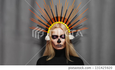 Creative Santa Muerte style portrait with purple Sugar Skull Makeup, tiara, and floral headdress. Fantasy art, mysterious glamour, gothic allure, surreal inspiration, divine feminine expression 131425920