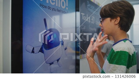 Schoolchild in Good Mood Interacting With AI Based Mood Tracking Tool in Modern Classroom Schoolchild in Good Mood Interacting With AI Based Mood Tracking Tool in Modern Classroom 131426006