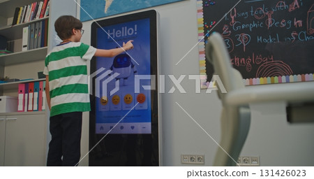 Boy Cheerfully Interacts With AI Mood Tracker 131426023