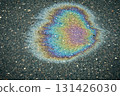 Iridescent gasoline puddle creating a colorful abstract texture on wet asphalt 131426030