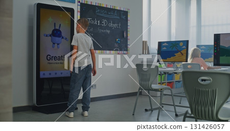 Schoolboy Uses Interactive Digital Screen, Talks Classmate. Boys Study STEM Classroom Schoolboy Uses Interactive Digital Screen, Talks Classmate. Boys Study STEM Classroom 131426057