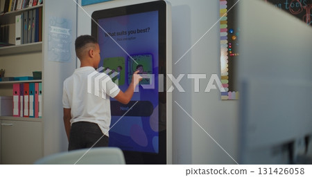 Young Boy Takes Personality Temperament Test on AI Mood Tracker Digital Screen Young Boy Takes Personality Temperament Test on AI Mood Tracker Digital Screen 131426058