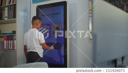 Young Boy Takes Personality Temperament Test on AI Mood Tracker Digital Screen Young Boy Takes Personality Temperament Test on AI Mood Tracker Digital Screen 131426071