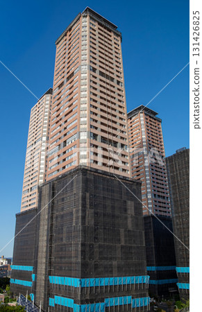 Scaffolding for repair work on the exterior walls of a tower apartment building 131426825