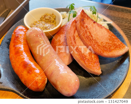 A platter of sausages and hams, a generous selection of meat products. A platter of sausages and hams, a generous selection of meat products. 131427049