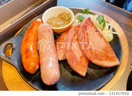 A platter of sausages and hams, a generous selection of meat products. A platter of sausages and hams, a generous selection of meat products. 131427050