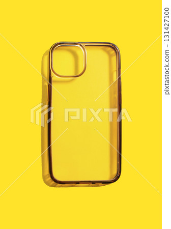 Transparent phone case displayed on bright yellow background, showcasing its clean design and structure, highlighting before and after use transformation concept Transparent phone case displayed on bright yellow background, showcasing its clean design and structure, highlighting before and after use transformation concept 131427100