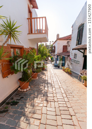 Narrow tourist streets of the Turkish city of Kas with white houses and colored windows. Beautiful ethnic resort town. Narrow tourist streets of the Turkish city of Kas with white houses and colored windows. Beautiful ethnic resort town. 131427900