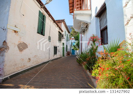 Narrow tourist streets of the Turkish city of Kas with white houses and colored windows. Beautiful ethnic resort town. 131427902