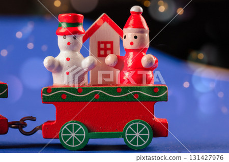 Christmas toy wooden red retro train decorated with children's snowmen and Christmas trees. Christmas toy wooden red retro train decorated with children's snowmen and Christmas trees. 131427976