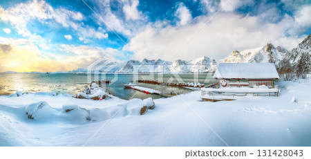 Amazing winter scenery with wooden houses in small fishing village and snowy  mountain peaks near Valberg. 131428043