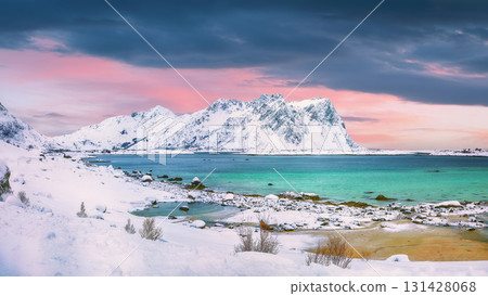 Dramatic snowy winter scene of Vestvagoy island with snowy mountain peaks on Lofoten Islands . Dramatic snowy winter scene of Vestvagoy island with snowy mountain peaks on Lofoten Islands . 131428068