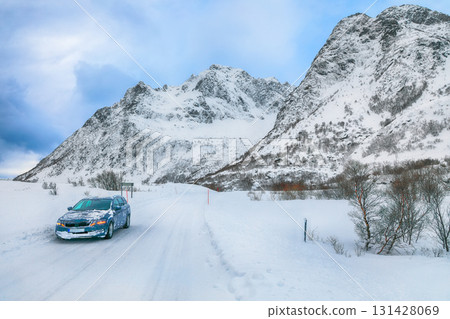 Dramatic snowy winter scene of Vestvagoy island with snowy mountain peaks on Lofoten Islands . Dramatic snowy winter scene of Vestvagoy island with snowy mountain peaks on Lofoten Islands . 131428069