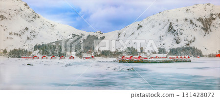 Amazing winter scenery with traditional Norwegian red wooden houses on the shore of Rolvsfjord. Amazing winter scenery with traditional Norwegian red wooden houses on the shore of Rolvsfjord. 131428072