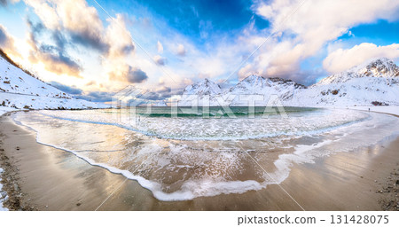 Amazing winter view of Vik beach during sunset with lots of snow  and snowy  mountain peaks near Leknes. 131428075