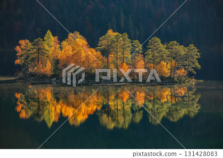 Amazing autumn landscape of islands with pine-trees in the middle of Eibsee lake. Amazing autumn landscape of islands with pine-trees in the middle of Eibsee lake. 131428083