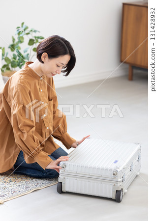 Woman packing clothes into a suitcase 131428932