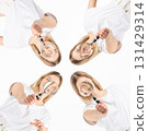 Studio portrait of women with magnifying glass 131429314