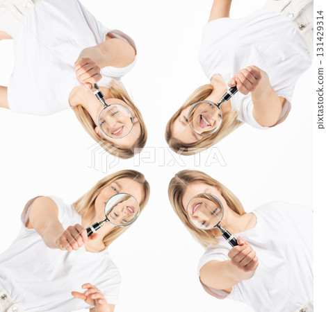Studio portrait of women with magnifying glass 131429314