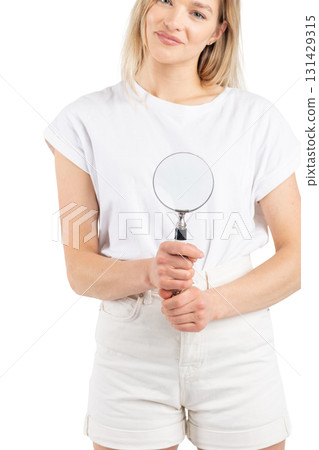 Studio portrait of woman with magnifying glass Studio portrait of woman with magnifying glass 131429315