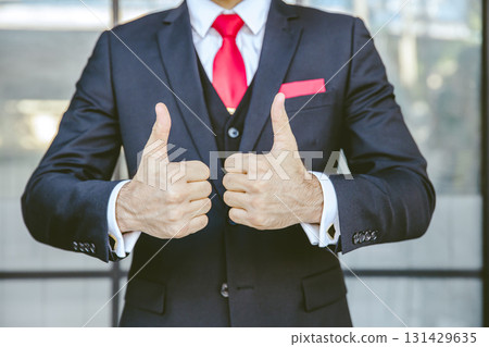 Two thumbs up business man close up at hand. male in suit show good best successful gesture. 131429635