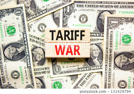 Trade tariff war symbol. Concept word Tariff war on beautiful wooden blocks. Dollar bills. Beautiful dollar bills background. Business trade tariff wars concept. Copy space. 131429794