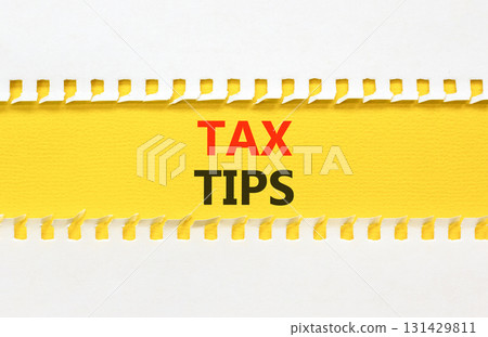Tax tips symbol. Concept word Tax tips on beautiful white paper. Beautiful yellow paper background. Business tax tips concept. Copy space. Tax tips symbol. Concept word Tax tips on beautiful white paper. Beautiful yellow paper background. Business tax tips concept. Copy space. 131429811