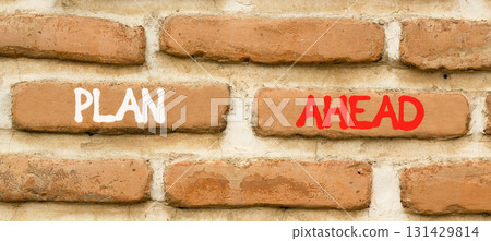 Plan ahead symbol. Concept word Plan ahead on beautiful old brown brick wall. Beautiful old brown brick wall background. Old brick wall. Business plan ahead concept. Copy space. 131429814