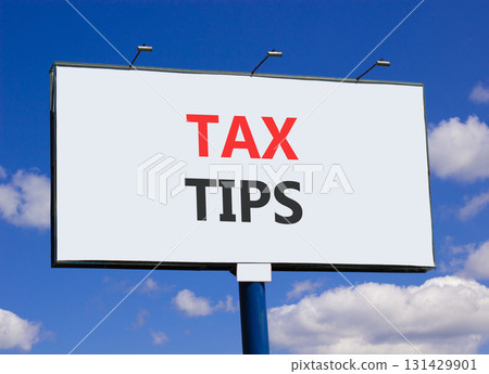 Tax tips symbol. Concept word Tax tips on beautiful white billboard. Beautiful blue sky and clouds background. Business tax tips concept. Copy space. Tax tips symbol. Concept word Tax tips on beautiful white billboard. Beautiful blue sky and clouds background. Business tax tips concept. Copy space. 131429901