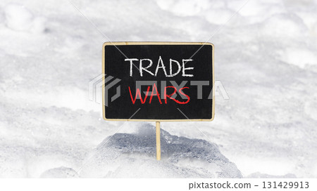 Trade wars symbol. Concept word Trade wars on beautiful black blackboard. Beautiful white snow background. White snow. Black blackboard. Business trade wars concept. Copy space. 131429913
