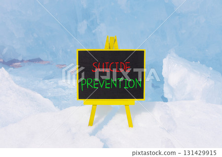 Suicide prevention symbol. Concept words Suicide prevention on beautiful black yellow blackboard. Beautiful blue ice background. Psychological and suicide prevention concept. Copy space. Suicide prevention symbol. Concept words Suicide prevention on beautiful black yellow blackboard. Beautiful blue ice background. Psychological and suicide prevention concept. Copy space. 131429915