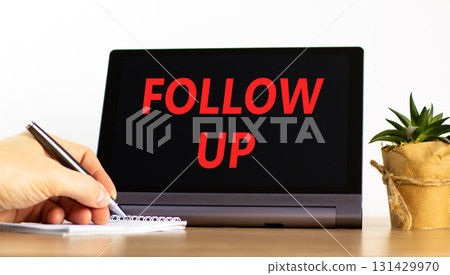 Follow up symbol. Concept word Follow up on beautiful black tablet. Businessman's hand with pen. Calculator. Beautiful white background. Business follow up concept. Copy space. Follow up symbol. Concept word Follow up on beautiful black tablet. Businessman's hand with pen. Calculator. Beautiful white background. Business follow up concept. Copy space. 131429970