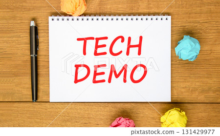 Tech demo symbol. Concept word Tech demo on beautiful white note. Black pen, colored paper. Beautiful wooden background. Business tech demo concept. Copy space. Tech demo symbol. Concept word Tech demo on beautiful white note. Black pen, colored paper. Beautiful wooden background. Business tech demo concept. Copy space. 131429977